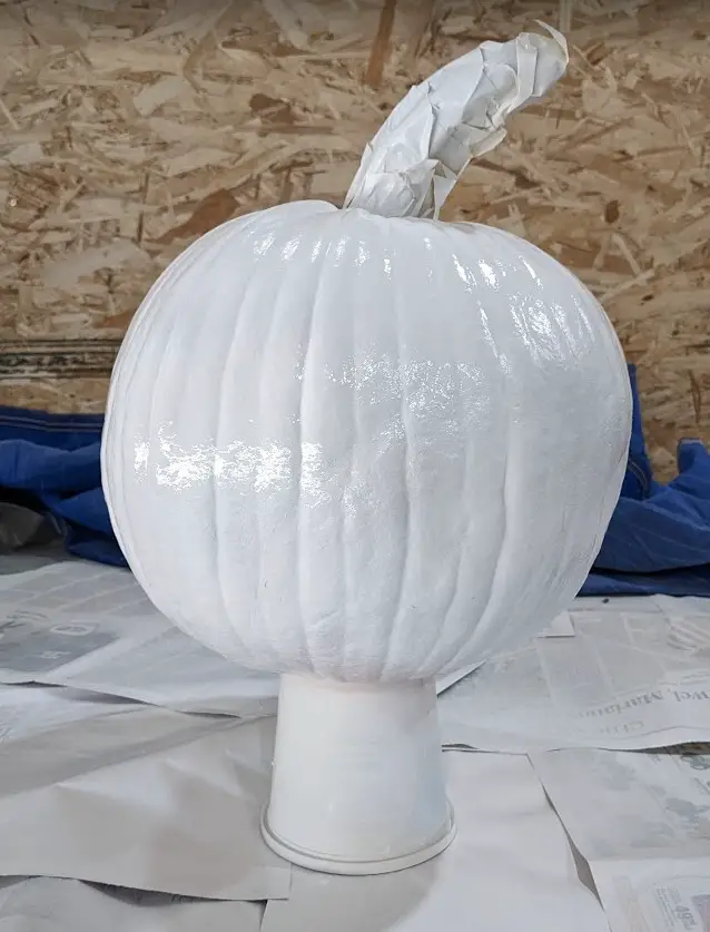 4 coats of white paint on pumpkin